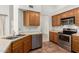 Kitchen featuring stainless steel appliances, oak cabinets, tiled flooring, and a built-in dishwasher at 6420 W Beverly Ln, Glendale, AZ 85306