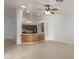 Open-concept living area featuring tile flooring, a ceiling fan, and a kitchen bar at 6420 W Beverly Ln, Glendale, AZ 85306