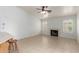 Bright living room with tile flooring, a fireplace, and natural light from shuttered windows at 6420 W Beverly Ln, Glendale, AZ 85306