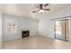 Bright living room with tile flooring, a fireplace, and a sliding glass door to the exterior at 6420 W Beverly Ln, Glendale, AZ 85306