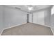 This bedroom has a closet with sliding doors, gray walls, and gray carpet at 6808 N 11Th St, Phoenix, AZ 85014