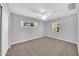 This bedroom has two windows with gray walls, gray carpet, and a closet at 6808 N 11Th St, Phoenix, AZ 85014