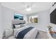 A calming bedroom featuring a gray tufted headboard, plush gray carpet, and a view of the yard through the window at 6808 N 11Th St, Phoenix, AZ 85014