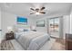 Comfortable main bedroom with a queen bed, stylish lamps, a ceiling fan, and a window view of the neighborhood at 6808 N 11Th St, Phoenix, AZ 85014