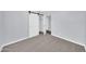 This bedroom features sliding closet door, gray walls, and gray carpet at 6808 N 11Th St, Phoenix, AZ 85014