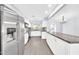 Spacious kitchen with stainless appliances, white cabinets, granite counters, and an island with bar seating at 6808 N 11Th St, Phoenix, AZ 85014