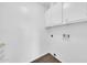 This laundry room features white walls and tile floors with hookups for a washer and dryer at 6808 N 11Th St, Phoenix, AZ 85014