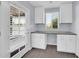 This office features white cabinets and counter tops with a door to the backyard at 6808 N 11Th St, Phoenix, AZ 85014