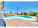 This backyard features a beautiful private pool surrounded by brick pavers and lush greenery at 6808 N 11Th St, Phoenix, AZ 85014