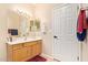 This bathroom has a single sink vanity, white cabinets, and neutral walls at 7031 S 32Nd Pl, Phoenix, AZ 85042