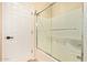 Tiled tub/shower combo with sliding doors and tile surround plus a door at 7031 S 32Nd Pl, Phoenix, AZ 85042