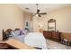 Relaxing bedroom with a large bed, ceiling fan, and ensuite bathroom at 7031 S 32Nd Pl, Phoenix, AZ 85042