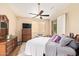 Comfortable bedroom with ceiling fan, a bed with patterned bedding, and natural light at 7031 S 32Nd Pl, Phoenix, AZ 85042
