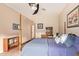 This bedroom has a ceiling fan, tiled floors, and plenty of natural light at 7031 S 32Nd Pl, Phoenix, AZ 85042