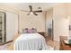 Bedroom featuring light-colored walls, a ceiling fan, and sliding glass doors at 7031 S 32Nd Pl, Phoenix, AZ 85042