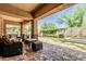 Covered backyard patio with outdoor seating overlooking the garden, spa and landscape at 7242 W Rowel Rd, Peoria, AZ 85383