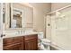 Bathroom with wood cabinets, white countertops, glass shower, and large mirror at 7242 W Rowel Rd, Peoria, AZ 85383