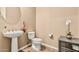 Powder room features pedestal sink and modern fixtures at 7242 W Rowel Rd, Peoria, AZ 85383