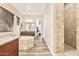 Bathroom with a soaking tub, vanity, and a walk-in shower with beige tiling throughout at 7242 W Rowel Rd, Peoria, AZ 85383