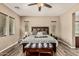 Main bedroom features a decorative headboard, ceiling fan, and neutral colors at 7242 W Rowel Rd, Peoria, AZ 85383