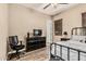 Bedroom with wood floors, ceiling fan and dark metal bed frame and dresser at 7242 W Rowel Rd, Peoria, AZ 85383
