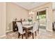 Dining area with rustic wood table and access to backyard pool at 7242 W Rowel Rd, Peoria, AZ 85383