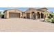 Charming home with a spacious driveway, two-car garage, and stone accents on the front columns at 7242 W Rowel Rd, Peoria, AZ 85383