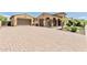 Elegant home featuring an expansive driveway and attractive architectural details, enhancing curb appeal at 7242 W Rowel Rd, Peoria, AZ 85383