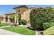 Charming home exterior with lush landscaping, colorful flowers, and a well-manicured lawn at 7242 W Rowel Rd, Peoria, AZ 85383
