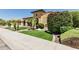 Inviting home exterior boasts manicured landscaping, decorative shrubbery, and a well-maintained lawn at 7242 W Rowel Rd, Peoria, AZ 85383