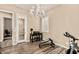Bright home office featuring a stylish chandelier, desk and home fitness equipment at 7242 W Rowel Rd, Peoria, AZ 85383