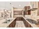 Gourmet kitchen featuring granite countertops, stainless steel appliances, and custom cabinets at 7242 W Rowel Rd, Peoria, AZ 85383