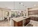 Open concept kitchen flowing into the living and dining areas, perfect for entertaining guests at 7242 W Rowel Rd, Peoria, AZ 85383
