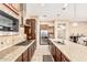 Modern kitchen with stainless steel appliances, granite countertops, and a center island with seating at 7242 W Rowel Rd, Peoria, AZ 85383