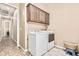 Laundry room with cabinets and washer/dryer at 7242 W Rowel Rd, Peoria, AZ 85383