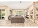 Living room features stone fireplace, tile floors, and large window at 7242 W Rowel Rd, Peoria, AZ 85383