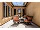 Cozy outdoor patio with comfortable seating, string lights, and a covered pergola at 7242 W Rowel Rd, Peoria, AZ 85383