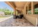 Backyard patio with outdoor seating overlooking pool, spa and manicured landscape at 7242 W Rowel Rd, Peoria, AZ 85383