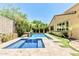 Sparkling pool and spa surrounded by lush landscaping in a private backyard at 7242 W Rowel Rd, Peoria, AZ 85383