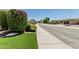 Picturesque street view with well-maintained homes, mature landscaping, and a tranquil neighborhood setting at 7242 W Rowel Rd, Peoria, AZ 85383