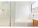 Bright bathroom featuring a separate glass-enclosed shower and soaking tub under a window at 764 E Shannon St, Chandler, AZ 85225