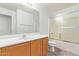 Bathroom featuring a large mirror, wooden cabinets, and bathtub with shower at 764 E Shannon St, Chandler, AZ 85225