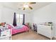 Bright bedroom with ceiling fan, large window, and pink bedspread at 764 E Shannon St, Chandler, AZ 85225