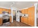 Kitchen boasts stainless steel appliances, wood cabinets, granite countertops, and adjacent laundry area at 764 E Shannon St, Chandler, AZ 85225