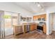 Bright kitchen with stainless steel appliances, granite countertops, and natural light from backyard window at 764 E Shannon St, Chandler, AZ 85225