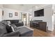 Spacious living room with a large sectional sofa, a TV, and neutral decor at 764 E Shannon St, Chandler, AZ 85225