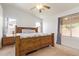 Spacious main bedroom features carpeted floors, ceiling fan, and plenty of natural light at 764 E Shannon St, Chandler, AZ 85225