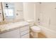 Bathroom with granite vanity, white cabinets, and a shower-over-tub with tile backsplash at 8055 W Sanna St, Peoria, AZ 85345