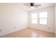 Bright bedroom featuring neutral tones, tile floors, ceiling fan, and natural light from two windows at 8055 W Sanna St, Peoria, AZ 85345