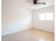 Neutral bedroom with tile floors, a ceiling fan, and a bright window, providing lots of natural light at 8055 W Sanna St, Peoria, AZ 85345
